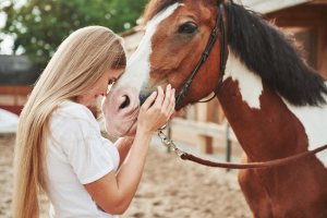 It's Never Too Late For Horses at Any Age a woman kissing a brown and white hors